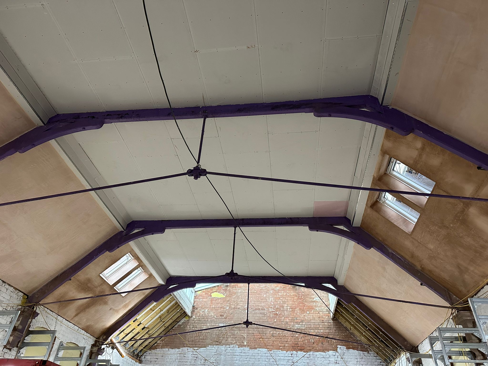 Large vaulted ceiling plastering work completed in Birmingham showing smooth professional finish